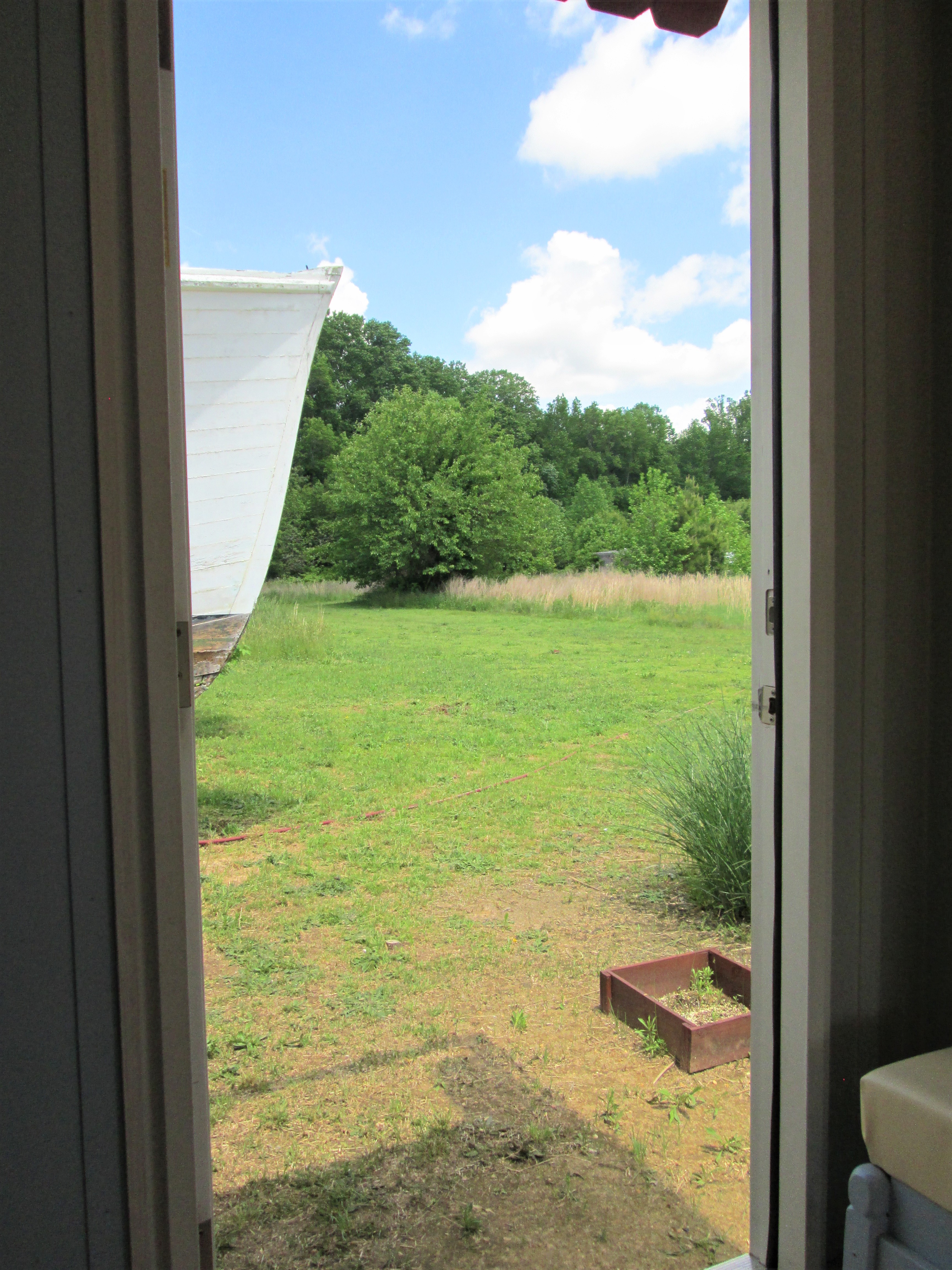 View out a Tiny House Container bathroom door.